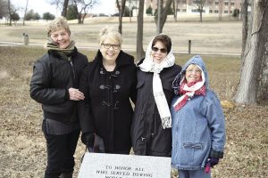 Four ladies stand around new World War I memorial
